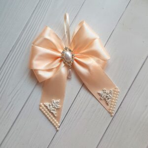 Set of 9 handmade cream Christmas tree bows decorated with pearls, brooches, and lace details in a gift box