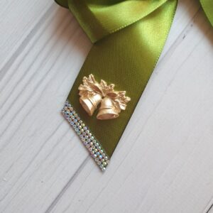 Green silk Christmas bows arranged on Christmas tree branches