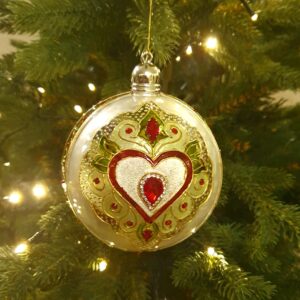 10 cm acrylic Christmas ornament in stained glass style with hand-painted red and green pattern, gold accents, and sparkling crystals glowing in holiday lights