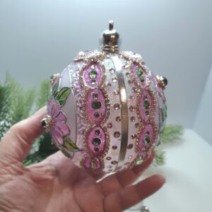 Reverse side of a pink floral Christmas ornament with stained glass-inspired painting
