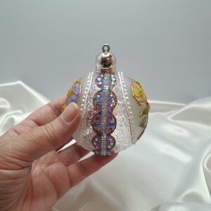 stained-glass-inspired Christmas ornament with glittering cap