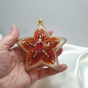 Hand-painted transparent star Christmas ornament with a red-orange pattern following the star shape