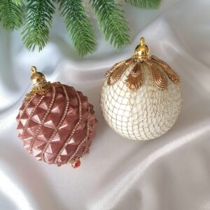 Powder-pink, gold, and white Christmas baubles with sparkling decorative details