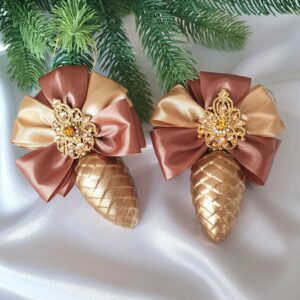 Powder-pink, gold, and white Christmas ornaments with decorative bows
