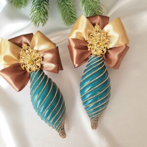 Elongated turquoise and pink Christmas ornaments with large decorative bows