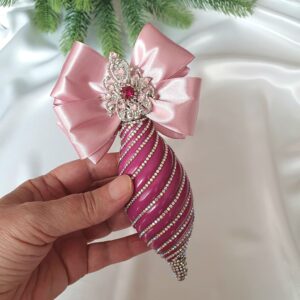 Elongated fuchsia Christmas ornaments with large decorative bows